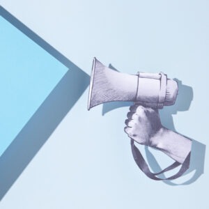 paper hand holding megaphone